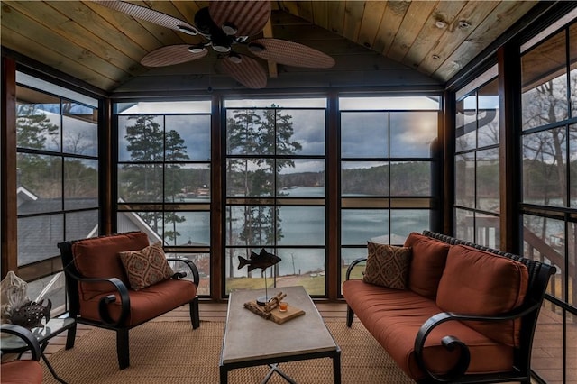 sunroom / solarium with lofted ceiling, ceiling fan, wooden ceiling, and a water view