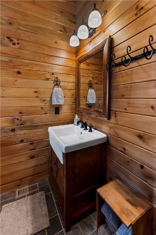 bathroom with wooden walls and vanity