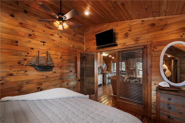 bedroom with high vaulted ceiling, wood finished floors, wood ceiling, and wooden walls