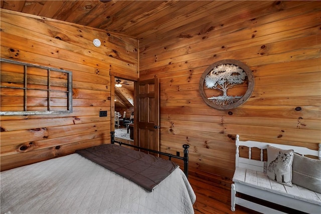 bedroom with wood walls, wood finished floors, and wood ceiling