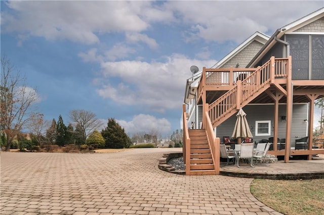 view of play area featuring stairway and a wooden deck