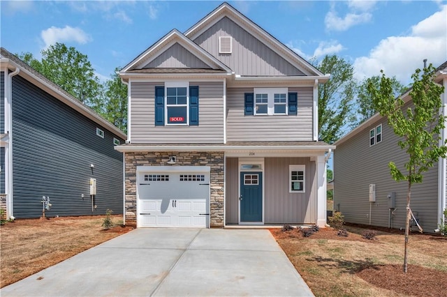 craftsman-style home featuring a garage, board and batten siding, driveway, and stone siding