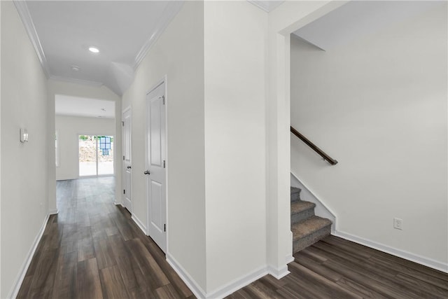corridor featuring crown molding, baseboards, recessed lighting, and dark wood-type flooring