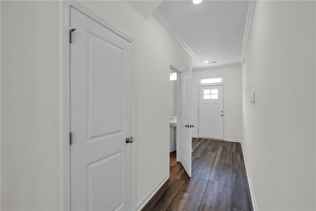 corridor with crown molding, baseboards, recessed lighting, and dark wood-style floors