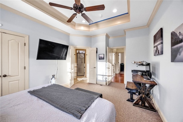 bedroom featuring recessed lighting, baseboards, carpet, a raised ceiling, and crown molding