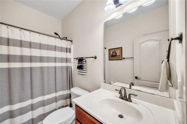 bathroom featuring vanity, toilet, and a shower with curtain