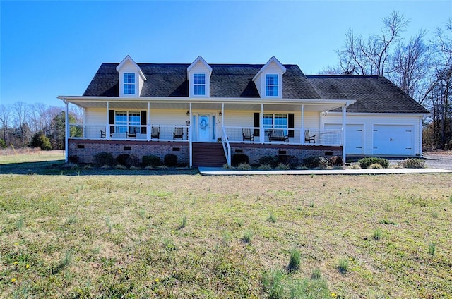 view of front of home featuring an attached garage, a porch, and a front yard