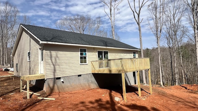 view of property exterior featuring roof with shingles, crawl space, and a wooden deck