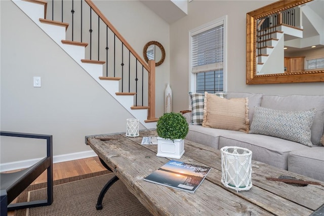 interior space with stairway, baseboards, and wood finished floors