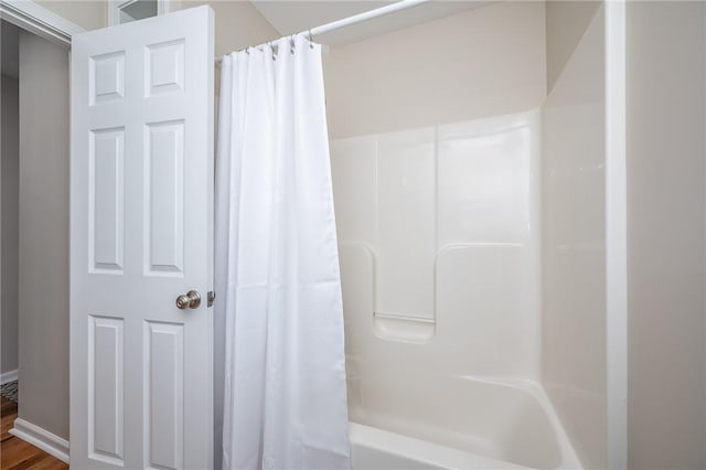 bathroom featuring shower / tub combo with curtain