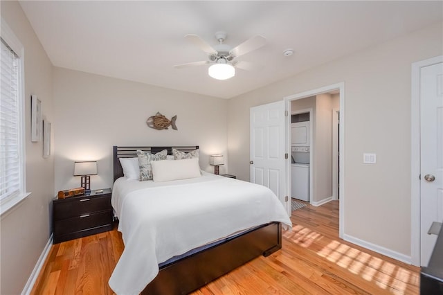 bedroom featuring ceiling fan, light wood-style flooring, and baseboards