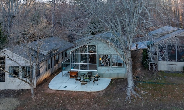 back of house with a sunroom and a patio area