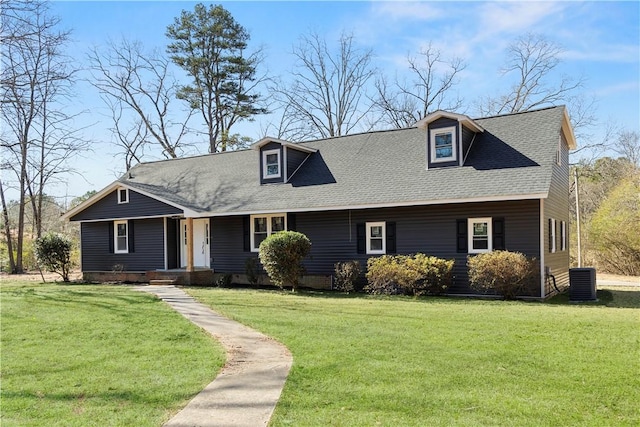 new england style home with a shingled roof, a front lawn, and central air condition unit