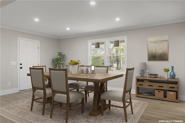 dining room featuring baseboards, ornamental molding, light wood-type flooring, and recessed lighting