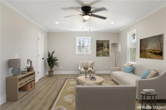 living area with recessed lighting, light wood-style flooring, ornamental molding, ceiling fan, and baseboards