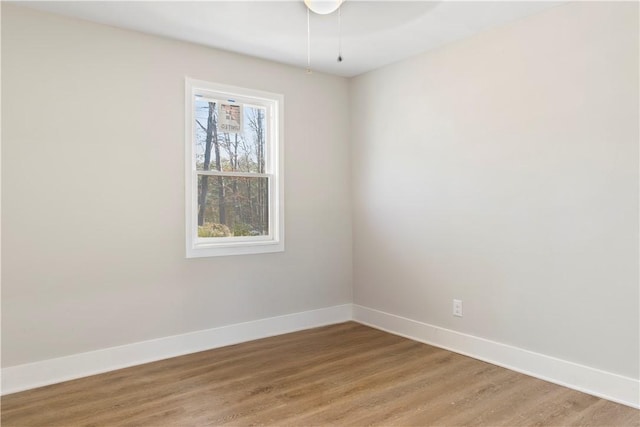 empty room featuring baseboards and light wood-style floors