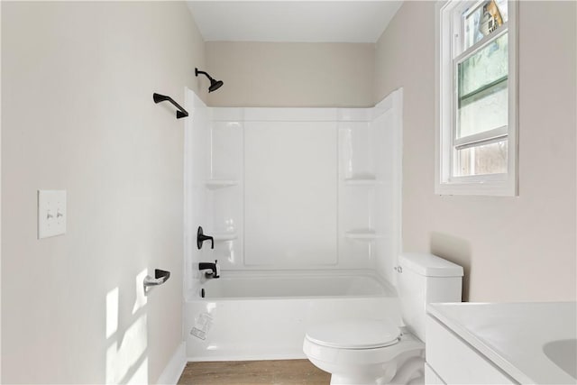 full bathroom featuring vanity, bathtub / shower combination, wood finished floors, and toilet