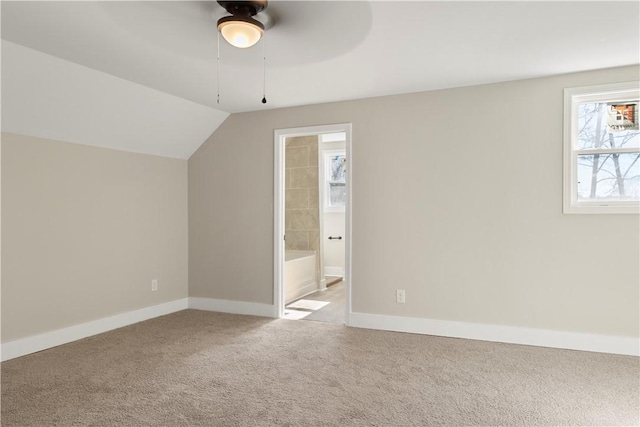 bonus room with lofted ceiling, carpet, a ceiling fan, and baseboards