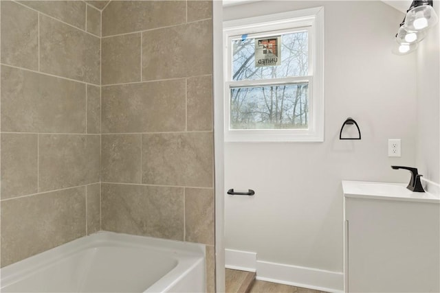 bathroom featuring vanity, baseboards, and wood finished floors