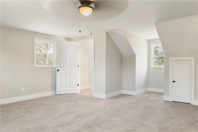 bonus room featuring carpet, lofted ceiling, and baseboards