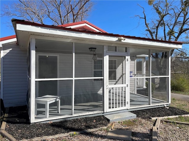 view of outbuilding with a sunroom