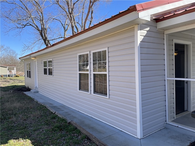 view of side of home featuring a lawn