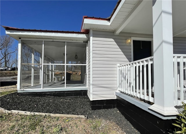 view of property exterior with a sunroom