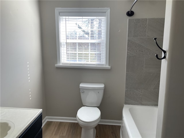 full bathroom featuring vanity, wood finished floors, toilet, and baseboards