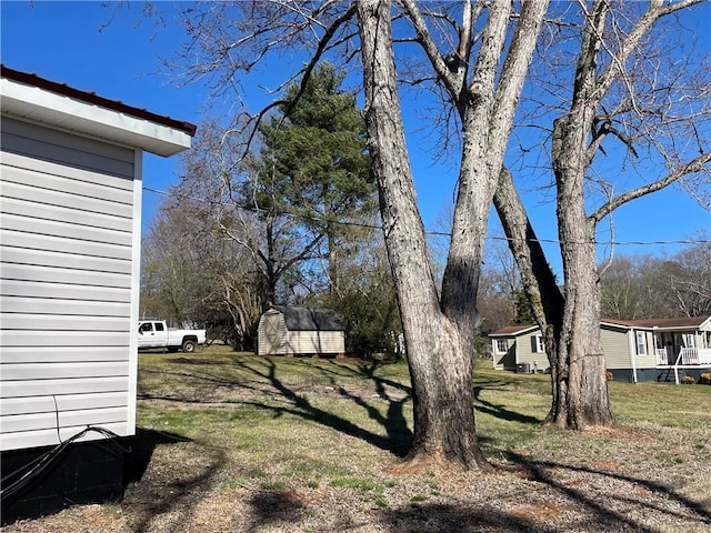 view of yard featuring an outbuilding and a shed