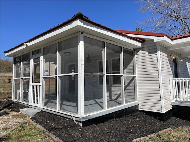 view of side of property featuring metal roof