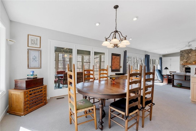 dining room featuring french doors, recessed lighting, visible vents, light carpet, and ceiling fan with notable chandelier