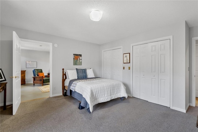 carpeted bedroom with baseboards and multiple closets