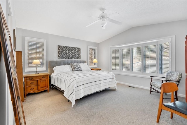 bedroom featuring lofted ceiling, multiple windows, baseboards, and light colored carpet