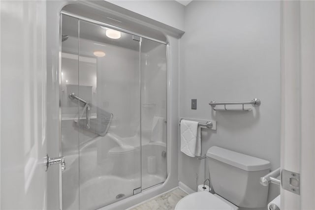 full bath with a stall shower, baseboards, and toilet