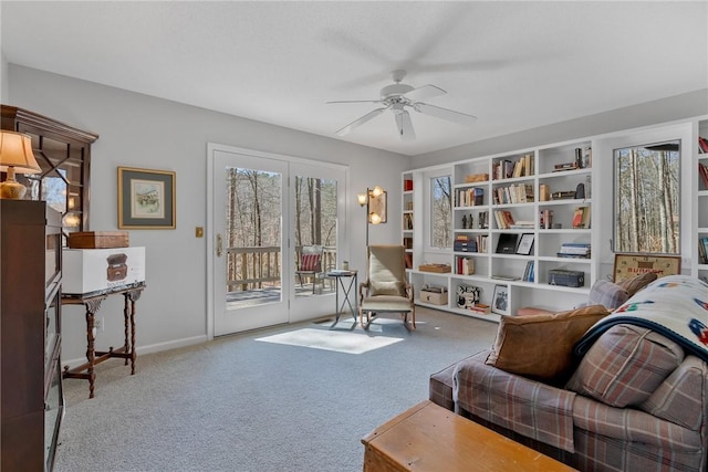 sitting room with baseboards, a ceiling fan, and carpet flooring