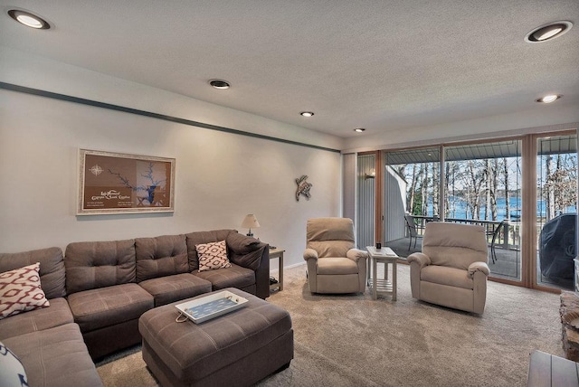 living area featuring a textured ceiling, recessed lighting, and light colored carpet