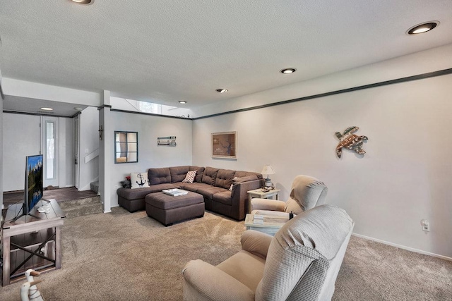 living room with carpet, a textured ceiling, baseboards, and stairs