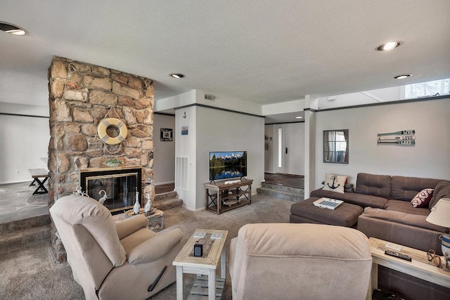 living room featuring visible vents, a fireplace, a textured ceiling, and carpet flooring