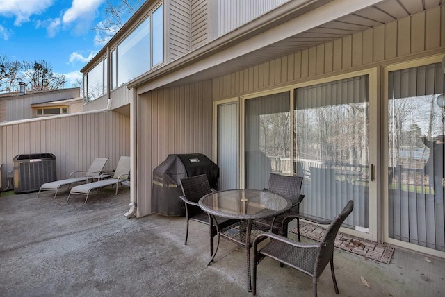 view of patio featuring cooling unit, outdoor dining space, and area for grilling