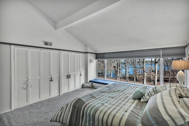 carpeted bedroom featuring vaulted ceiling with beams, a textured ceiling, and visible vents