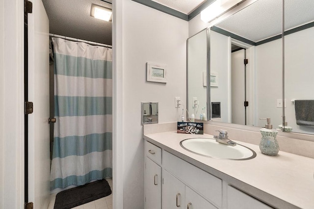 bathroom with a shower with curtain, a textured ceiling, and vanity