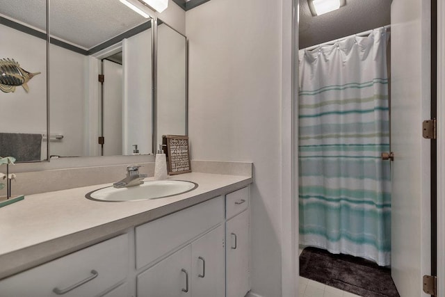 bathroom with a shower with shower curtain, a textured ceiling, and vanity