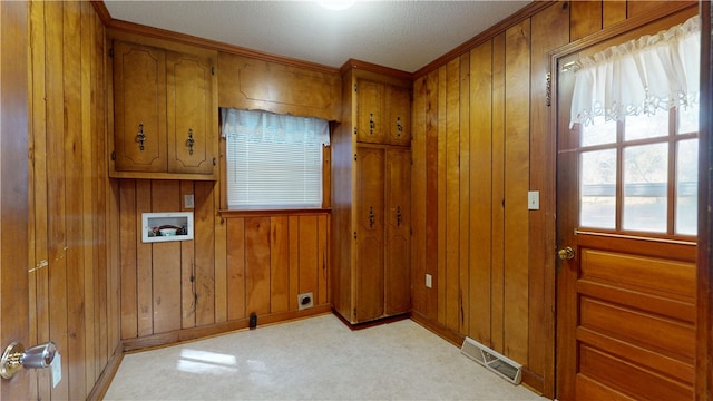 laundry area featuring hookup for a washing machine, light colored carpet, cabinet space, visible vents, and wood walls