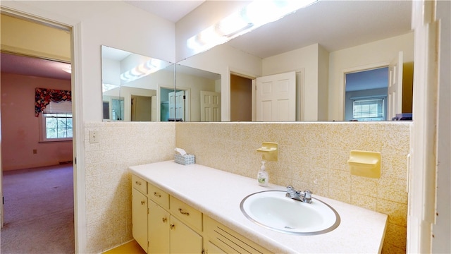 bathroom featuring tile walls, a wealth of natural light, and vanity