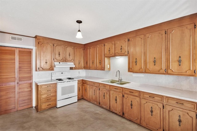 kitchen featuring brown cabinets, visible vents, electric range, a sink, and under cabinet range hood