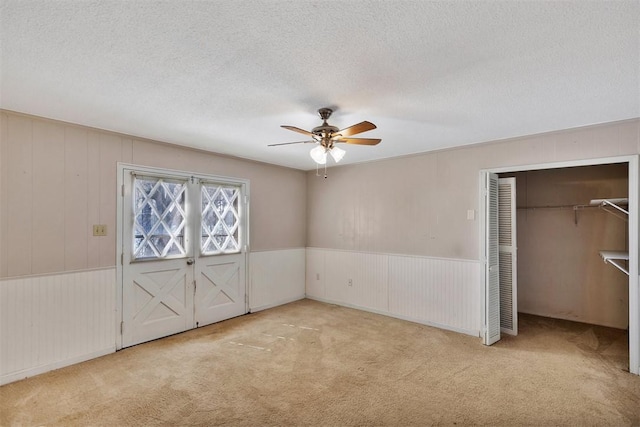 unfurnished bedroom featuring a textured ceiling and carpet