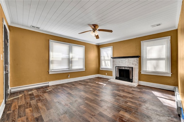 unfurnished living room with visible vents, a baseboard heating unit, crown molding, and wood finished floors