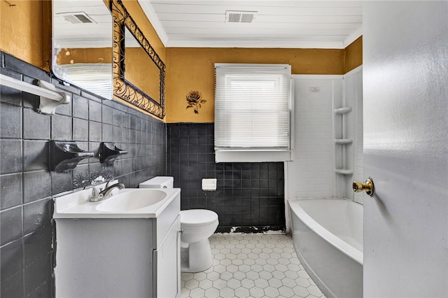 bathroom with a tub to relax in, visible vents, toilet, and vanity