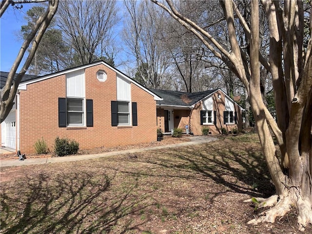 view of front of house featuring brick siding and an attached garage