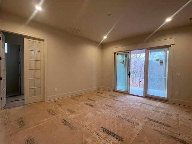 unfurnished room featuring recessed lighting, visible vents, and baseboards